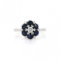 14K White Gold, Blue Sapphire and Diamond, Flower Ring. The design features, one round brilliant cut, Diamonds (0.23ct TDW, G colour, SI2 clarity), claw set. Surrounded by, 6 round cut, royal blue, Sapphires (1.24ct TSW, eye clean clarity), claw set. Accompanied by, 6 round brilliant cut, Diamonds (0.08ct TDW, G-H colour, I1 clarity), claw set. Ring Size M 1/2.

Insurance Valuation Provided by Vendor: $5,590.00
LE-612